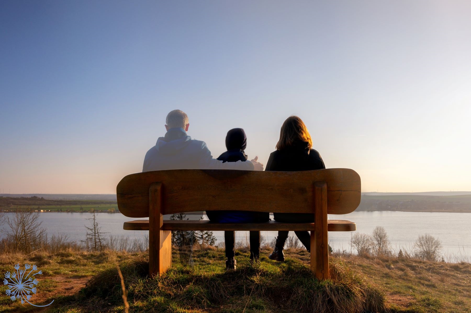 Family sitting on bench with ghost of father missing